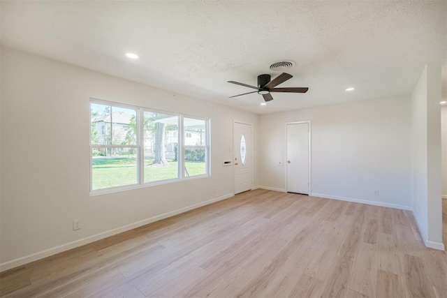 9419 Campbell Rd, Houston, TX 77080 - empty room with ceiling fan, light wood-style floors, baseboards, recessed lighting, and a textured ceiling