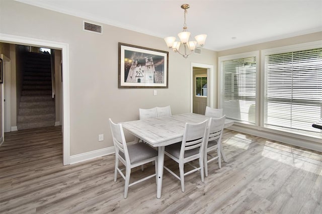 27140 Fm 365, Beaumont, TX 77705 - dining area with a chandelier, light wood-style flooring, stairway, crown molding, and baseboards