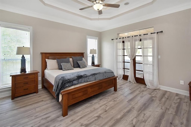 27140 Fm 365, Beaumont, TX 77705 - bedroom featuring a tray ceiling, multiple windows, crown molding, light wood finished floors, and baseboards