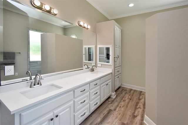 27140 Fm 365, Beaumont, TX 77705 - bathroom featuring ornamental molding, wood finished floors, double vanity, baseboards, and recessed lighting