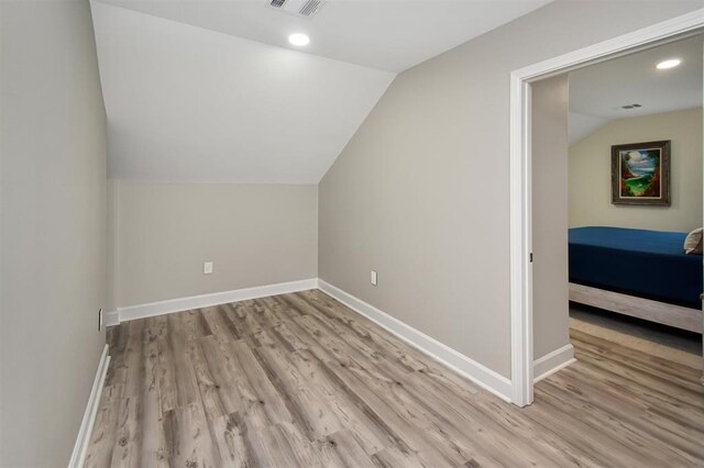 27140 Fm 365, Beaumont, TX 77705 - additional living space with vaulted ceiling, light wood finished floors, baseboards, and recessed lighting