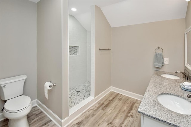 27140 Fm 365, Beaumont, TX 77705 - bathroom featuring toilet, wood finished floors, a tile shower, lofted ceiling, and double vanity