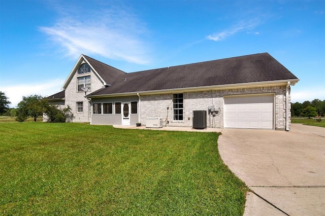 27140 Fm 365, Beaumont, TX 77705 - view of front of house with concrete driveway, cooling unit, an attached garage, brick siding, and a front lawn