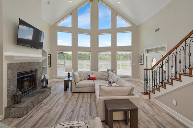27140 Fm 365, Beaumont, TX 77705 - living room with baseboards, healthy amount of natural light, ornamental molding, light wood-style flooring, and high vaulted ceiling