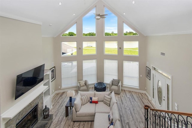27140 Fm 365, Beaumont, TX 77705 - living room with high vaulted ceiling, wood finished floors, ceiling fan, a glass covered fireplace, and ornamental molding