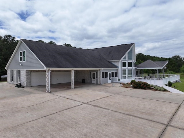 27140 Fm 365, Beaumont, TX 77705 - view of front of house with brick siding, concrete driveway, an attached garage, and covered porch