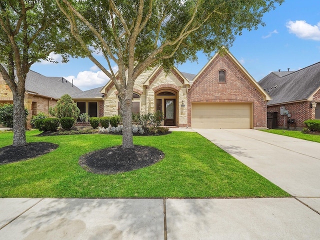 5411 Cedar Elm Ln, Fulshear, TX 77441 - view of front of home featuring brick siding, driveway, a front yard, and stone siding