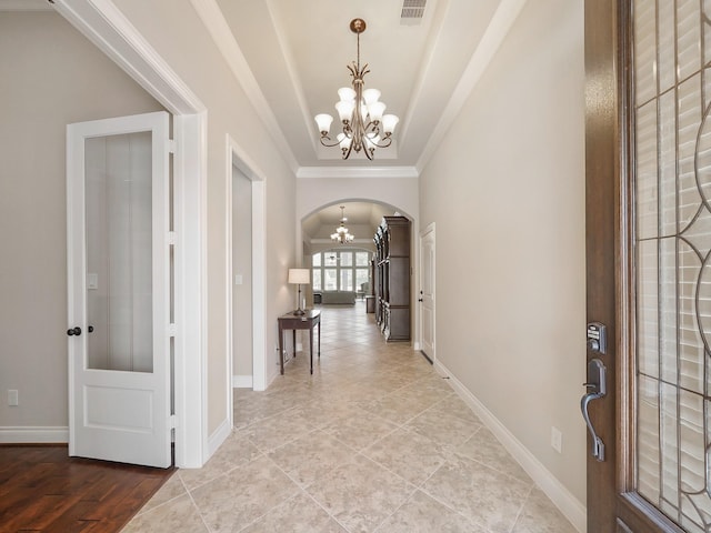 5411 Cedar Elm Ln, Fulshear, TX 77441 - entrance foyer with a chandelier, arched walkways, baseboards, light tile patterned floors, and ornamental molding