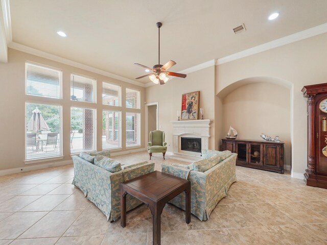 5411 Cedar Elm Ln, Fulshear, TX 77441 - living room featuring crown molding, light tile patterned floors, a fireplace with raised hearth, baseboards, and a ceiling fan