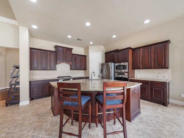 5411 Cedar Elm Ln, Fulshear, TX 77441 - kitchen featuring stainless steel appliances, decorative backsplash, a center island with sink, recessed lighting, and a sink