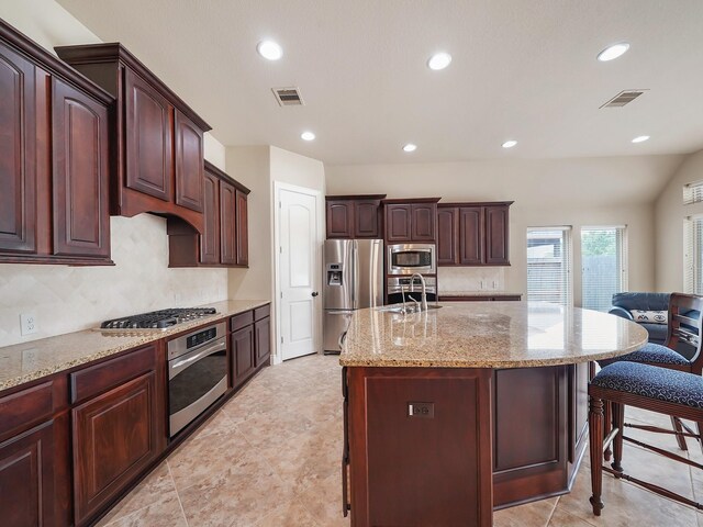 5411 Cedar Elm Ln, Fulshear, TX 77441 - kitchen with appliances with stainless steel finishes, a sink, recessed lighting, backsplash, and light stone counters