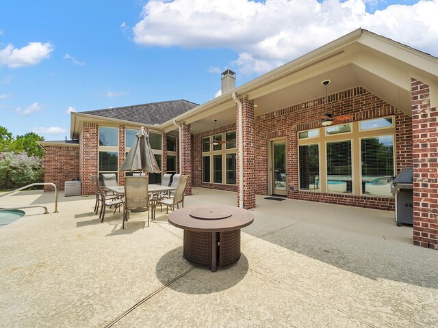 5411 Cedar Elm Ln, Fulshear, TX 77441 - view of patio / terrace featuring outdoor dining area, an outdoor pool, and a grill