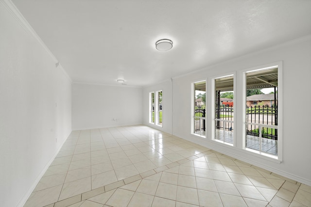 12310 New Brunswick Dr, Houston, TX 77089 - empty room featuring crown molding, light tile patterned floors, and baseboards