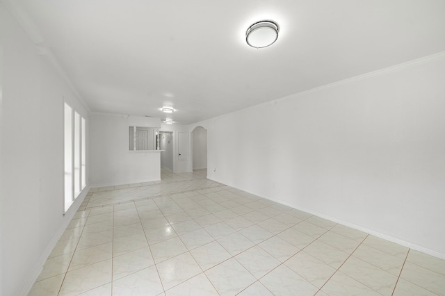 12310 New Brunswick Dr, Houston, TX 77089 - spare room with arched walkways, baseboards, light tile patterned floors, and crown molding