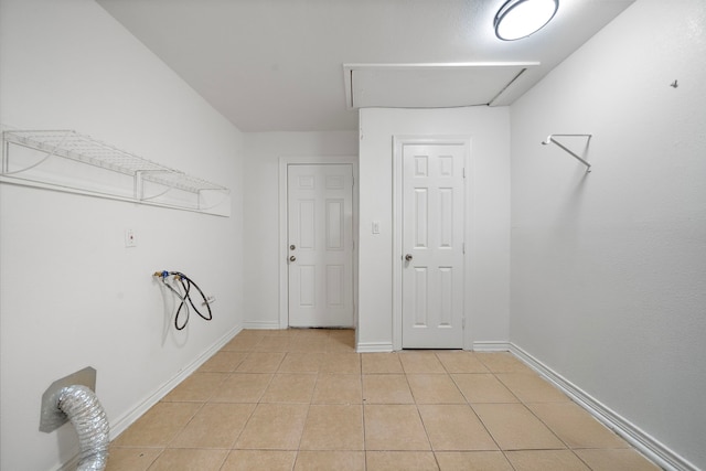12310 New Brunswick Dr, Houston, TX 77089 - laundry area featuring washer hookup, light tile patterned floors, and baseboards