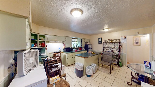 6130 Hartwick Rd, Houston, TX 77016 - kitchen featuring a textured ceiling, light tile patterned floors, open shelves, black microwave, and dark countertops