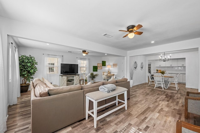 729 Kyle St, Angleton, TX 77515 - living area featuring a ceiling fan, a chandelier, light wood-type flooring, and recessed lighting