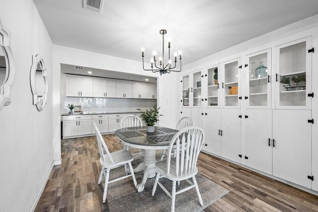 729 Kyle St, Angleton, TX 77515 - dining room with a chandelier, dark wood-style floors, and baseboards