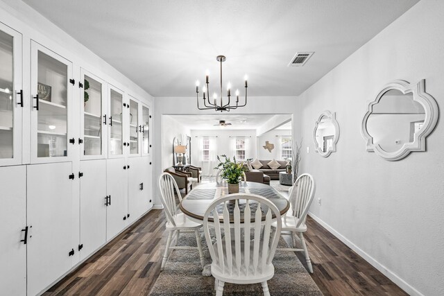729 Kyle St, Angleton, TX 77515 - dining space with a chandelier, baseboards, and dark wood-style flooring