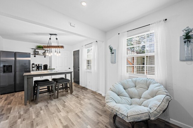 729 Kyle St, Angleton, TX 77515 - kitchen featuring stainless steel fridge with ice dispenser, light wood finished floors, baseboards, a chandelier, and recessed lighting
