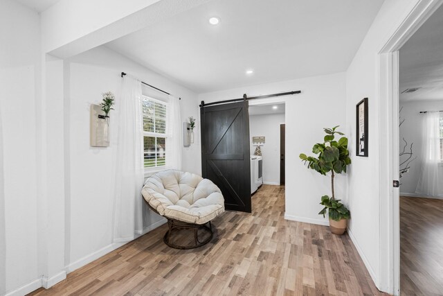 729 Kyle St, Angleton, TX 77515 - sitting room with light wood-style flooring, a barn door, recessed lighting, and baseboards