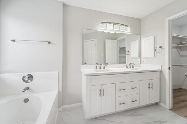 13038 Skymeadow Dr, Houston, TX 77082 - full bathroom featuring marble finish flooring, a bath, double vanity, and baseboards