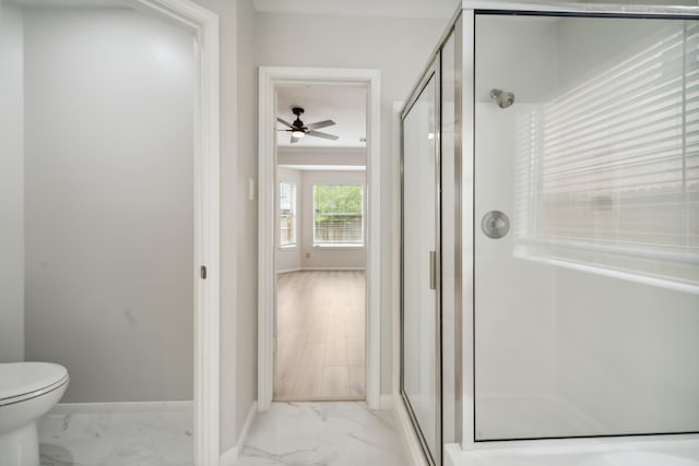 13038 Skymeadow Dr, Houston, TX 77082 - bathroom with marble look tile flooring, a stall shower, a ceiling fan, toilet, and baseboards