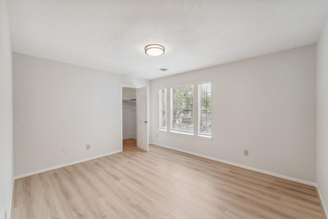 13038 Skymeadow Dr, Houston, TX 77082 - unfurnished bedroom with light wood-type flooring, baseboards, and a closet