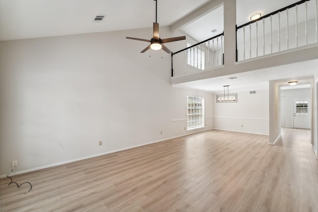 13038 Skymeadow Dr, Houston, TX 77082 - unfurnished living room with light wood-style flooring, a ceiling fan, healthy amount of natural light, beamed ceiling, and baseboards