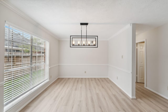 13038 Skymeadow Dr, Houston, TX 77082 - unfurnished dining area with ornamental molding, light wood-style flooring, a chandelier, and baseboards