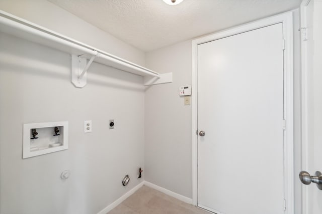 13038 Skymeadow Dr, Houston, TX 77082 - laundry room featuring gas dryer hookup, hookup for a washing machine, electric dryer hookup, a textured ceiling, and baseboards