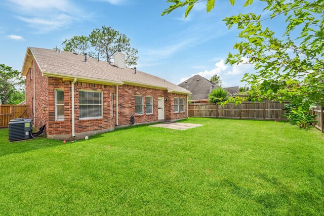 13038 Skymeadow Dr, Houston, TX 77082 - rear view of property featuring cooling unit, a chimney, brick siding, and roof with shingles