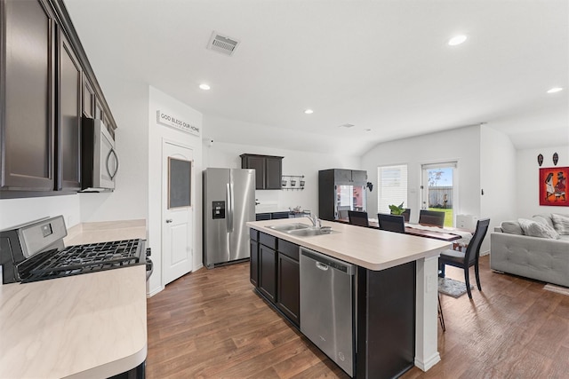 5159 Cherry Tallow Trl, Katy, TX 77449 - kitchen featuring appliances with stainless steel finishes, a sink, open floor plan, dark wood finished floors, and light countertops