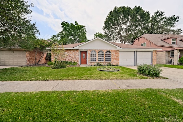 3247 Bolton Gardens Dr, Houston, TX 77066 - view of front of house with a garage, driveway, a front lawn, and brick siding