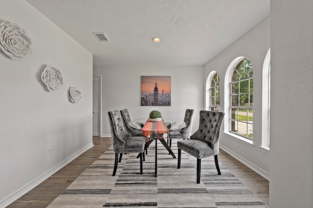 3247 Bolton Gardens Dr, Houston, TX 77066 - dining room with a textured ceiling, wood finished floors, baseboards, and recessed lighting