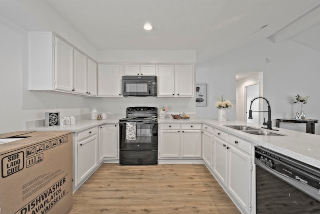 3247 Bolton Gardens Dr, Houston, TX 77066 - kitchen with black appliances, a sink, white cabinetry, light wood-type flooring, and recessed lighting