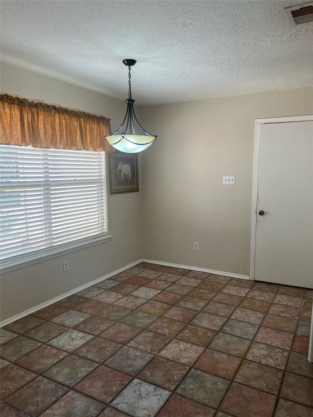 2134 Collingsfield Dr, Sugar Land, TX 77478 - spare room featuring a textured ceiling and baseboards