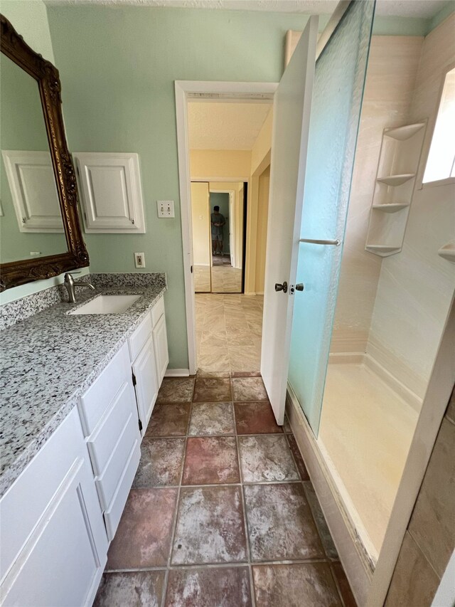 2134 Collingsfield Dr, Sugar Land, TX 77478 - full bath featuring a stall shower, vanity, and baseboards