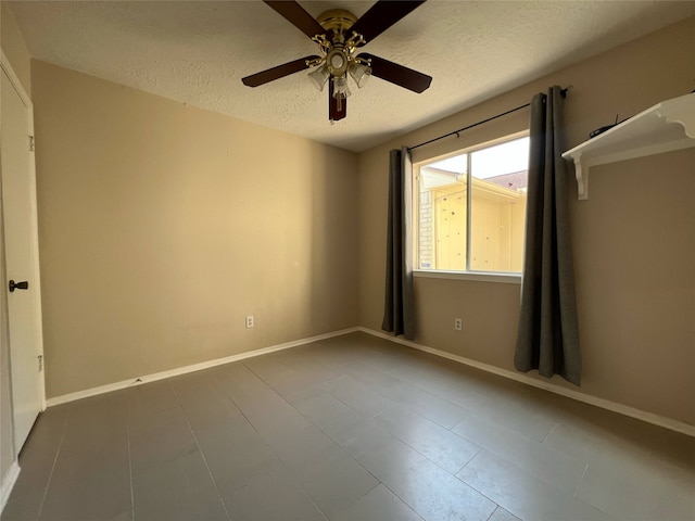 2134 Collingsfield Dr, Sugar Land, TX 77478 - spare room featuring a textured ceiling, a ceiling fan, baseboards, and tile patterned floors