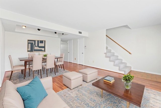 10345 Longmont Dr, Houston, TX 77042 - living area featuring wood finished floors, stairway, and baseboards