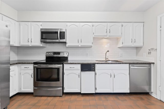 10345 Longmont Dr, Houston, TX 77042 - kitchen featuring stainless steel appliances, a sink, and white cabinetry