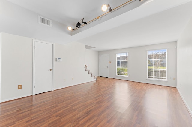 10345 Longmont Dr, Houston, TX 77042 - unfurnished living room featuring stairway, wood finished floors, and baseboards