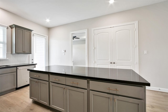 2517 S Houston Ave, Pearland, TX 77581 - kitchen with gray cabinets, stainless steel dishwasher, dark countertops, light wood-style flooring, and recessed lighting