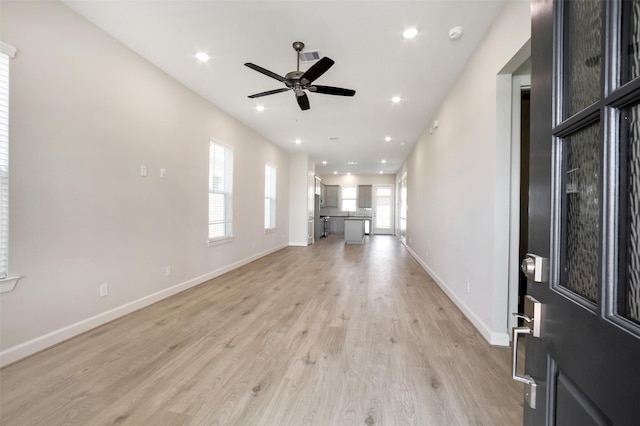 2517 S Houston Ave, Pearland, TX 77581 - unfurnished living room featuring ceiling fan, light wood-style floors, baseboards, and recessed lighting