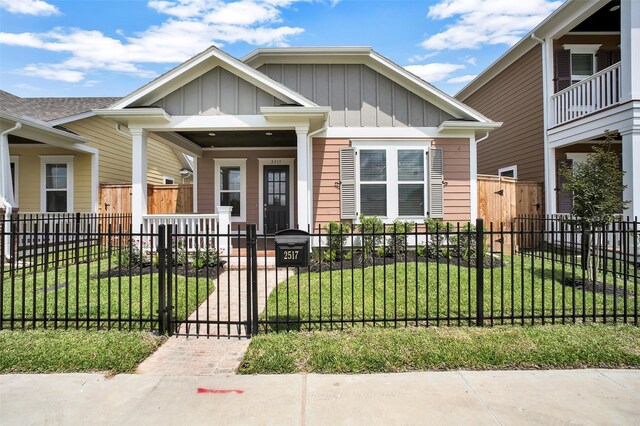2517 S Houston Ave, Pearland, TX 77581 - view of front facade with board and batten siding, covered porch, and a gate