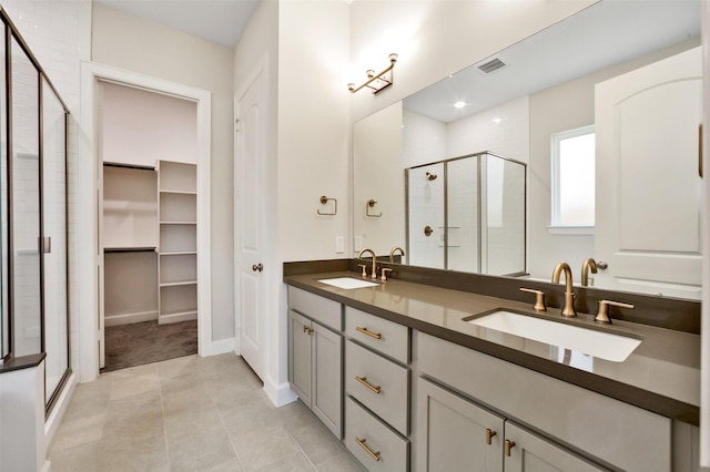 2517 S Houston Ave, Pearland, TX 77581 - bathroom with a shower stall, double vanity, tile patterned floors, and a walk in closet