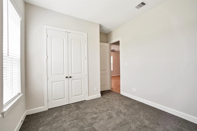2517 S Houston Ave, Pearland, TX 77581 - unfurnished bedroom with carpet, multiple windows, a closet, and baseboards
