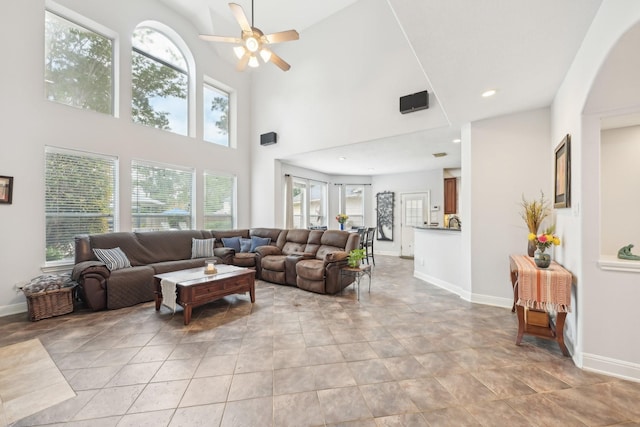 12106 Via Chianti Ct, Cypress, TX 77429 - living area with ceiling fan, arched walkways, baseboards, a high ceiling, and recessed lighting