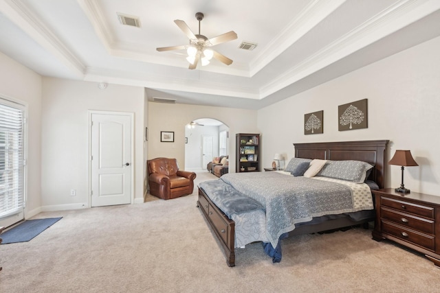 12106 Via Chianti Ct, Cypress, TX 77429 - bedroom featuring light colored carpet, arched walkways, a tray ceiling, ornamental molding, and a ceiling fan