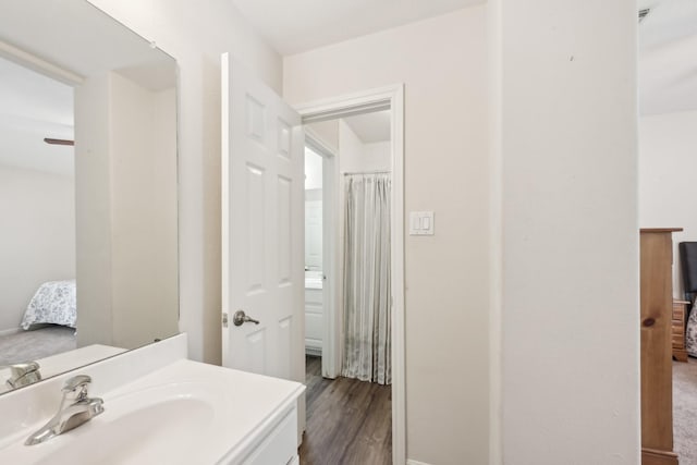 12106 Via Chianti Ct, Cypress, TX 77429 - ensuite bathroom with vanity, wood finished floors, baseboards, and ceiling fan